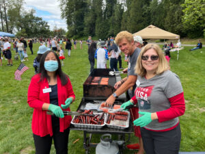 A family gathered around a grill